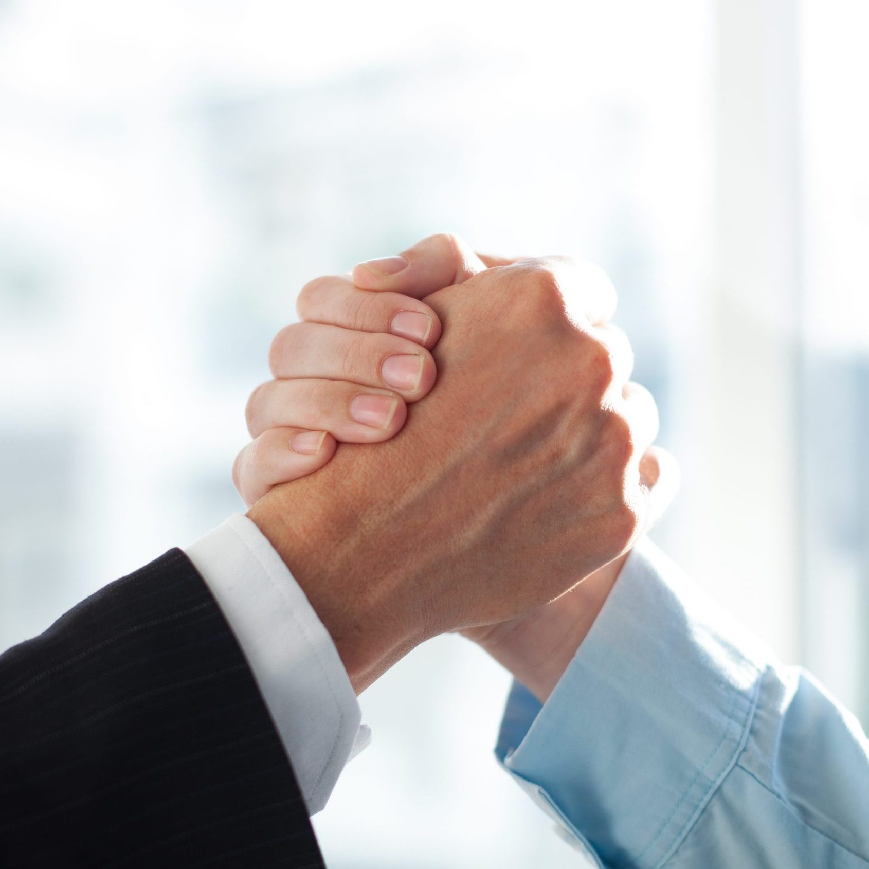 Close-up of two clasped hands of businessmen